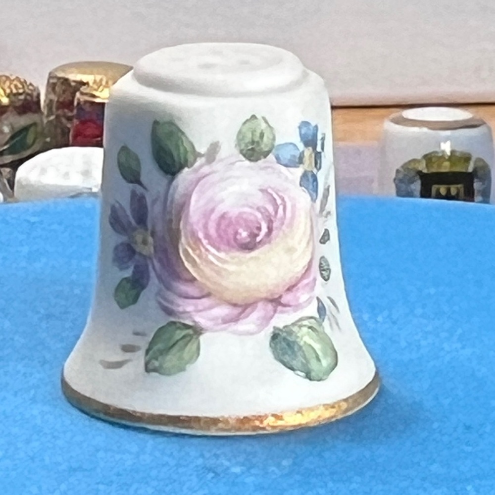 PK Royal Porcelain thimble with a pink rose motif and gold trim.